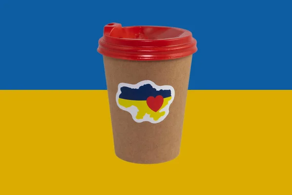 Disposable paper cup of coffee with a patriotic sticker \