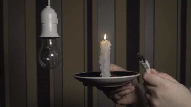 Man Dark Room Holds Burning Candle One Hand Electric Plug — Video Stock