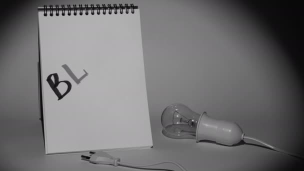 Notepad Electric Light Bulb Holder Plug Gray Background Lit Spotlight — Vídeo de stock