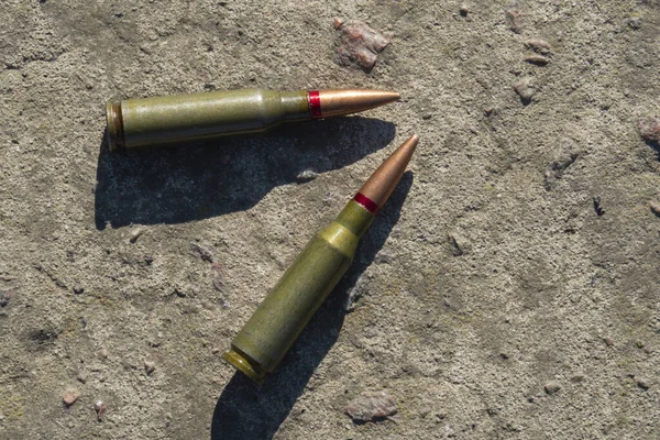 Two Rifle Cartridges Lie Concrete Surface Close — Stock Photo, Image