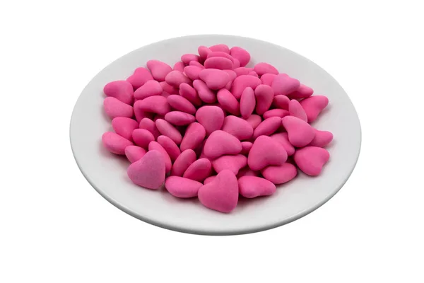 Biała Płyta Różowym Kształcie Serca Cukierki Zbliżenie Izolowane Białym Tle — Zdjęcie stockowe