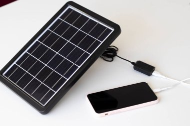 Küçük güneş paneli telefonu şarj ediyor