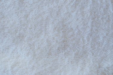 Arka plan olarak yumuşak bej örülmüş kumaş, yakın plan. Tüm resim için yumuşak kumaş.