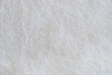 Angora ya da yün ile hafif arkaplan. Arka plan olarak yumuşak bej örülmüş kumaş, yakın plan. Tüm resim için yumuşak kumaş.
