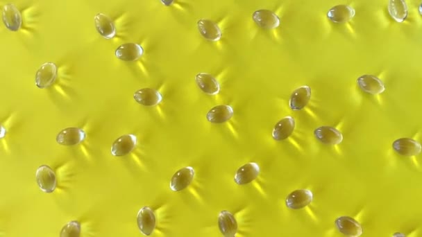 ビタミンDカプセル太陽の下で黄色の背景に散在しています 良い気分 サプリメントの使用の概念 — ストック動画