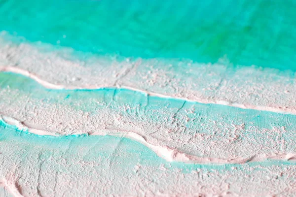 Fragment of a drawing of a turquoise sea or ocean with 3d waves. Artistic texture painted with acrylic paints. Volumetric painted picture of waves and sand, part of the close-up. Image for exhibition