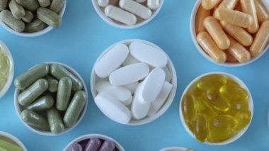 Mixed pill background, top view. Nutritional supplements, vitamins and organic minerals such as magnesium, zinc, calcium, fish oil, vitamin D, activated charcoal, curcumin, CoQ10, enzymes