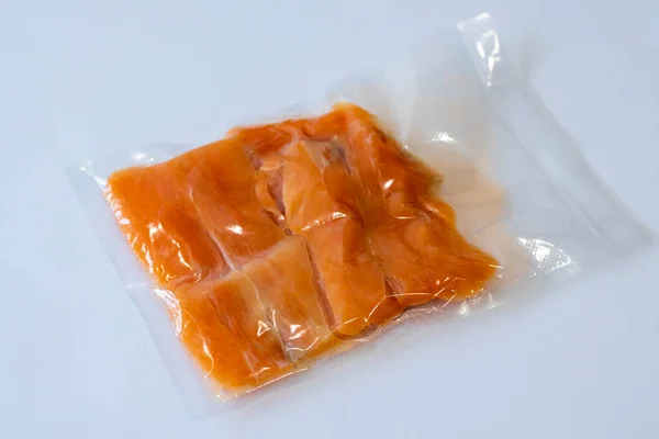 Vacuum packaging of salmon fillet fish for long term storage or Sous vide cooking. Using a vacuum packer for long term food storage. Top view