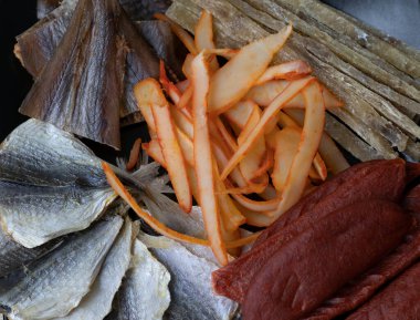 Dried Seafood Mix with Squid, Tuna, codfishon, yellow minke on Plate Top View. Close-up