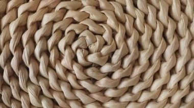 Round woven hyacinth mat carpet made from water hyacinth fibers for the kitchen on white background. Close-up with the camera zoomed out