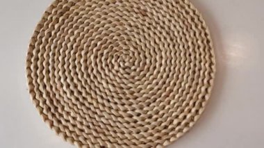 Round woven hyacinth mat carpet made from water hyacinth fibers for the kitchen on white background