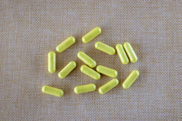 Yellow Quercetin Capsules Beige Natural Textured Background Dietary Supplement Top — Zdjęcie stockowe