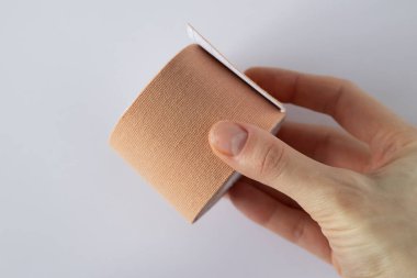 Special Physio Tape Rolling In a Womans Hand.