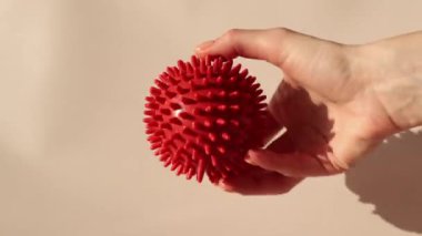 Spiky rubber massage ball for recovery and rehabilitation or for relaxation and massage. Fitness equipment. Concept of myofascial release. mfr - myofascial release.