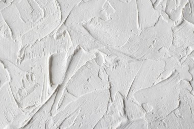 Close-up photo of a white putty textured wall. Textured Simplicity