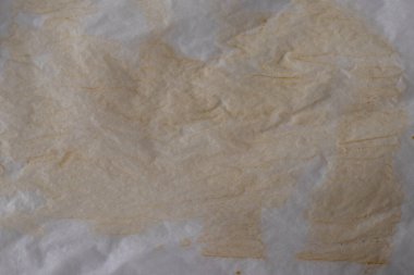 Old soiled used parchment for cooking. Background.