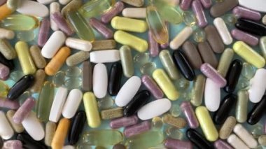 Background of colorful pills in the form of capsules and vitamins and supplements in close-up