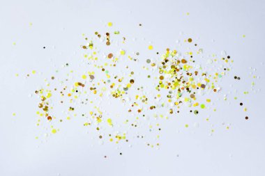 White background with glittery gold sequins.