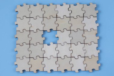 Assembled blank wooden puzzles with emphasis on the missing puzzle.