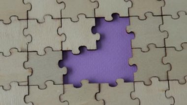 Missing heart-shaped puzzles. A background of puzzles with a light purple empty space