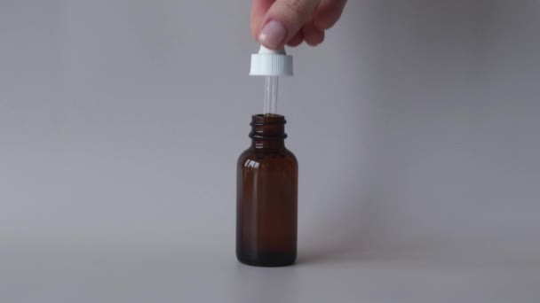 Young Womans Hand Holds Bottle Dropper Oil Serum Facial Body — Vídeo de stock