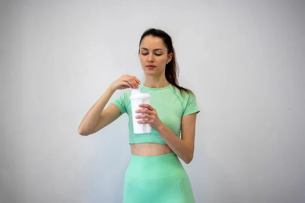 Young Slim Woman Sportswear Twisting Lid Sports Nutrition Shaker Gray —  Fotos de Stock