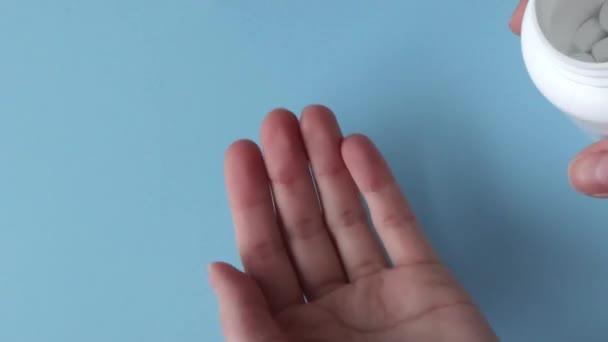 Woman Pours White Tablets Magnesium Supplements Her Hand Blue Background — Stockvideo