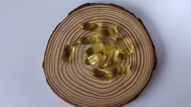 Woman Puts Capsules Fish Oil Stand Made Wood — Stock Video