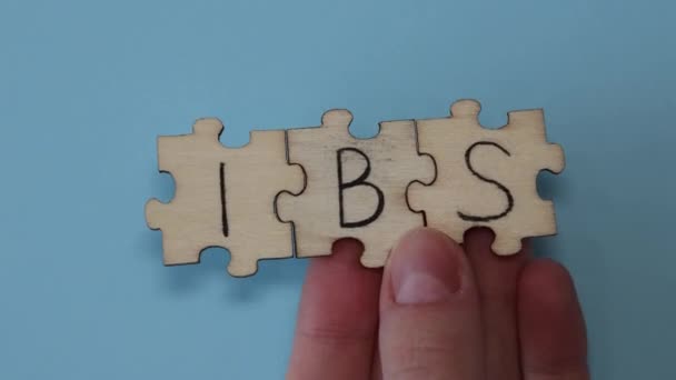 Ibs Irritable Bowel Syndrome Abbreviation Written Wooden Puzzles Blue Background — Stock Video