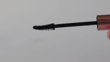 Beyaz arkaplanda siyah Mascara fırçası, yakın plan.