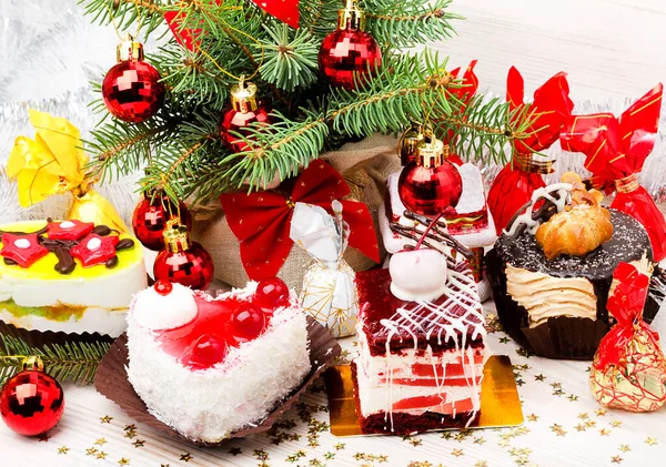 Assorted delicious cakes and sweets with New Year\'s decor. Dessert for any celebration and holiday.