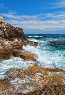 Black Sea. Crimea. Ukraine. Landscape scene, turquoise water, stones and blue sky with clouds. High quality photo