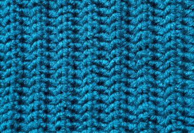 Kalıbın dokusu yün karışımı ipliğinden, berquoise renginde. Sıcak yün karışımı iplik yakın plan.