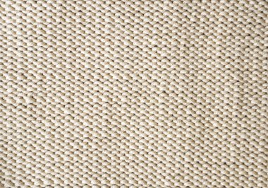 Pamuk ipliğinden yapılmış bej örülmüş doku. El yapımı konsept, hobi, geçmiş, moda online örgü kursu.