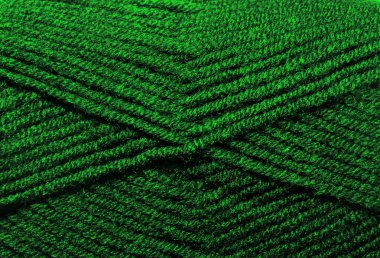 Yün karışımı ipliğin dokusu koyu yeşildir. Sıcak yün karışımı iplik yakın plan.