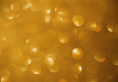 Metin için güzel altın bir arkaplan. Bulanık geçmişli şenlikli aydınlık, tebrik ederim..