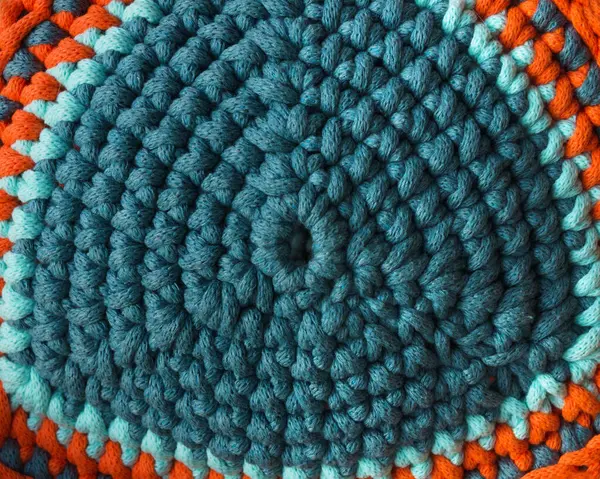 Cotton yarn. Cotton cord pattern in turquoise and orange. A fragment of a women's handbag made from ECO yarn