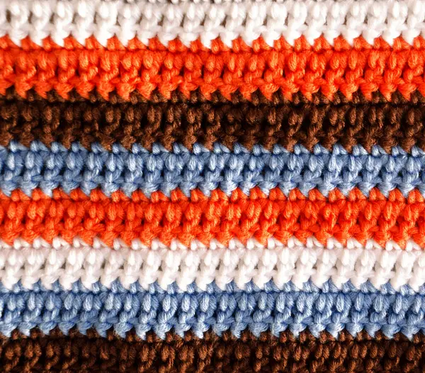 Crochet, pattern from multi-colored cotton threads, double crochet. Handmade concept, hobby, background, fashionable online knitting course.