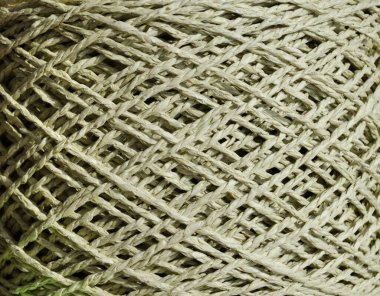 An olive skein of raffia is ready for knitting. Eco-friendly handmade material. Raffia close-up. clipart