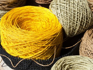 Raffia topları arka planda bir çuval bezine yakın çekim yapıyor. Raffia Skeins örgü örmeye hazır..