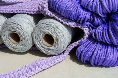 Polyester cords and bag. Durable synthetic cords for knitting string bags. clipart