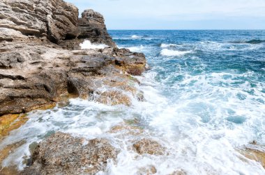 Black Sea. Crimea. Ukraine. Landscape scene, turquoise water, stones and blue sky with clouds. High quality photo