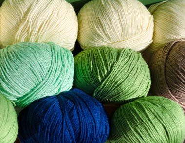 Yarn rolls close-up. Fashionable and colorful colors. Soft cotton yarn ready for knitting. clipart