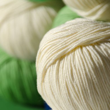 Close-up of a roll of milky yarn. Trendy and colorful colors. Soft cotton yarn ready for knitting. clipart