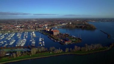 Dolly shot over the marina, view of historical buildings and houses on a lake in the Netherlands. Highe angle panorama view of the old town and harbor of Hoorn in the Netherlands