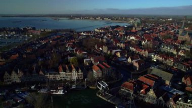 Aerial view over old picturesque town, stepped gable streets on the canals with drawbridge and boats on the quay. Blue morning in winter, Hoorn city the Netherlands