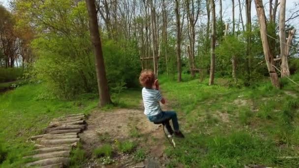 Revealing Shot Back View Brave Little Boy Goes Zipline Park — Stock Video