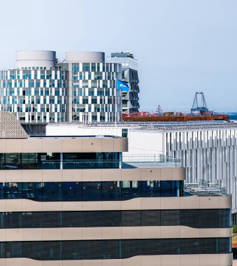 Portland Towers Corporate offices and the UN World Health Organization rise above the DFDS headquarters at Copenhagen harbor, showcasing modern architecture and a busy quay. Denmark 07-29-2024
