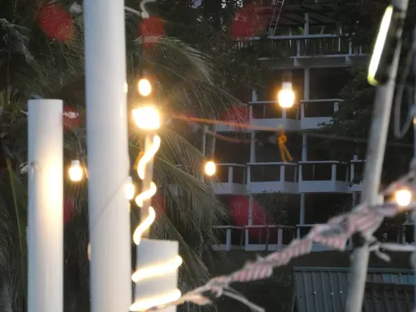 The background features lush green hills and clear blue water, creating a serene and relaxing coastal atmosphere  perfect for themes of vacation, leisure, and tropical tourism.