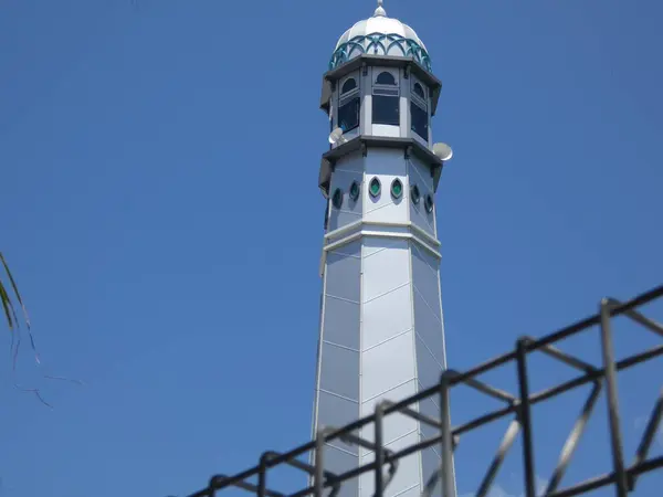The surrounding trees provide shade, creating a serene and peaceful atmosphere  perfect for themes of religion, culture, architecture, and travel.
